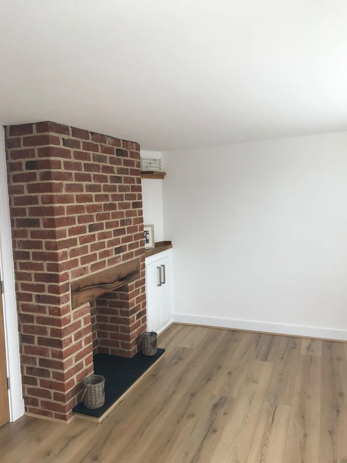 Laminate flooring fireplace room 01 – carpentry by JCK Carpentry & Building, Exeter