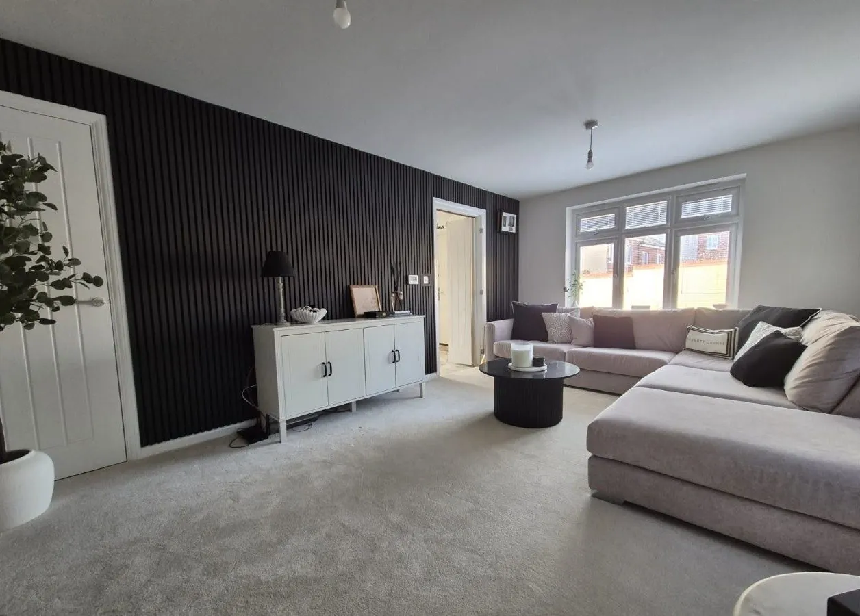 Black slatted wall panelling in a living room, Exeter